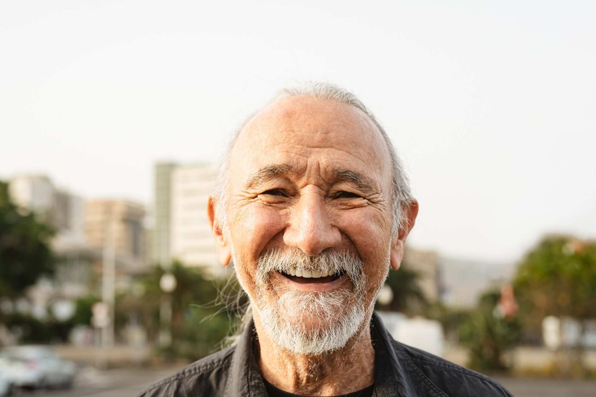 Happy senior man smiling in front of camera